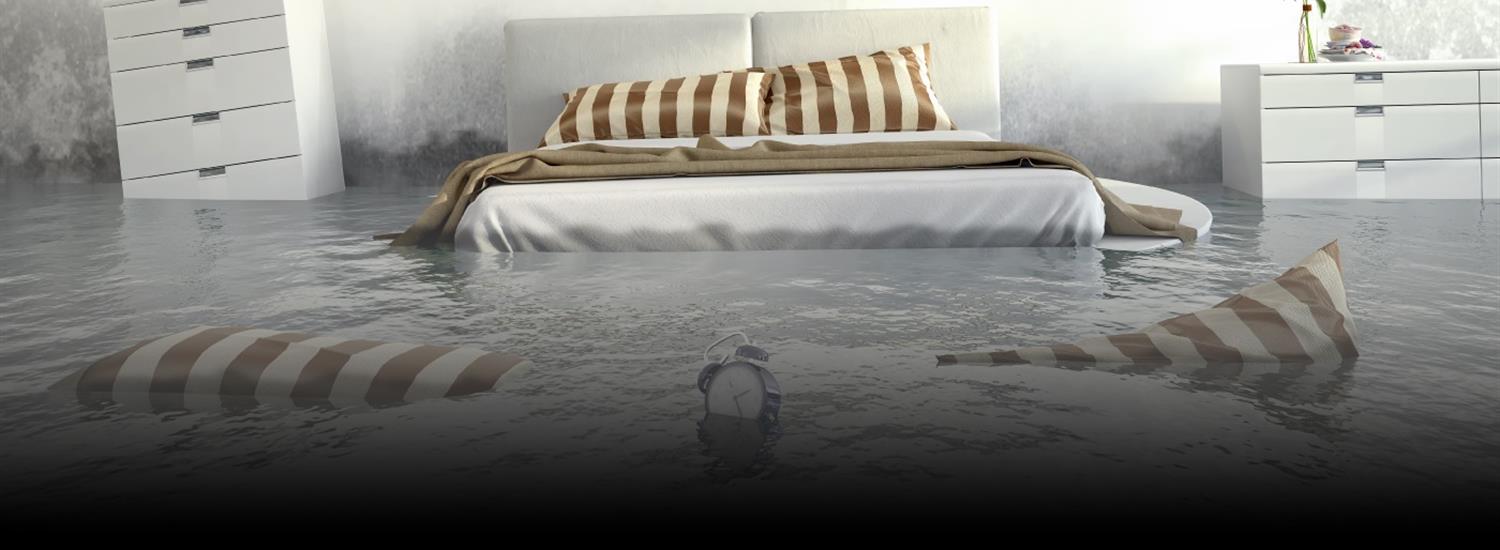 Banner - water flooding a bedroom with white furniture
