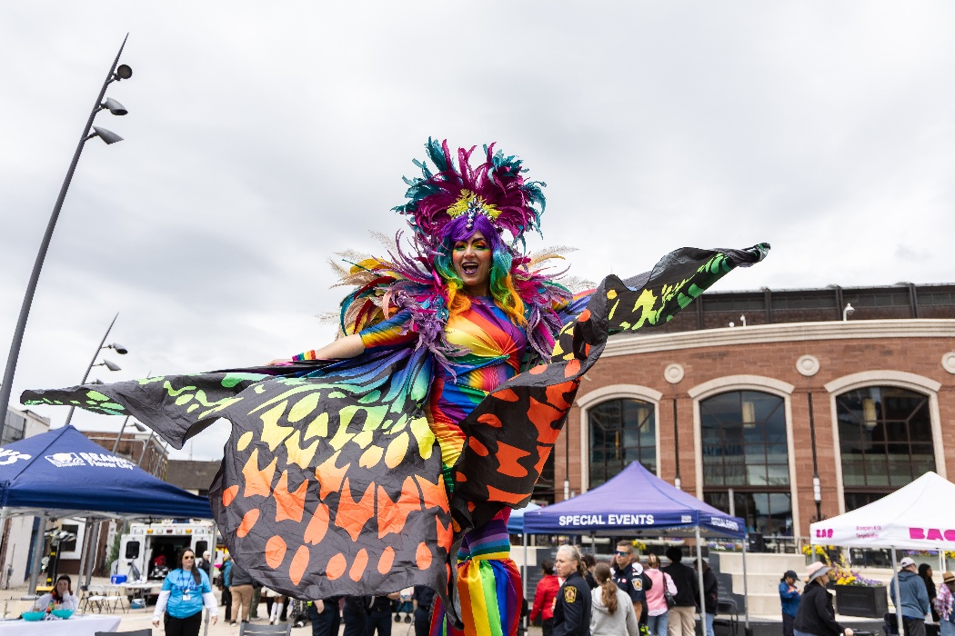 An image of a performer wearing a colourful costume at an outdoor event.