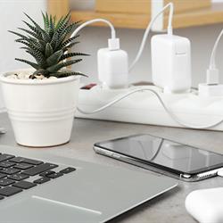 Image of various electronics devices being charged while connected to a power bar