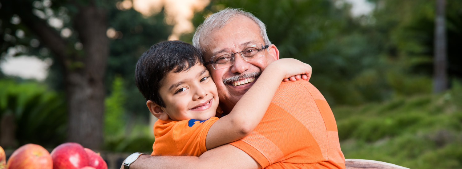 Page Banner - A senior and his grandchild hugging